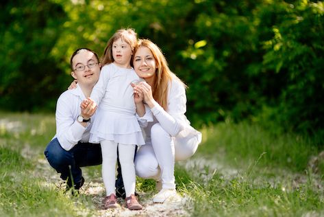 A child with Down syndrome smiles - loyalty for special needs