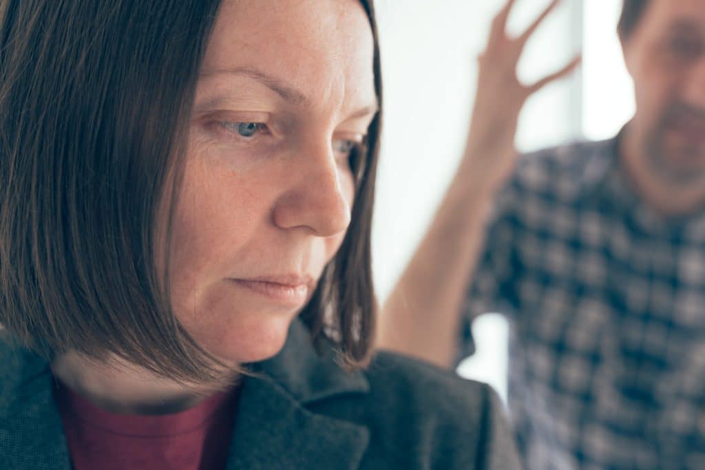 Husband and wife arguing, man yelling at woman