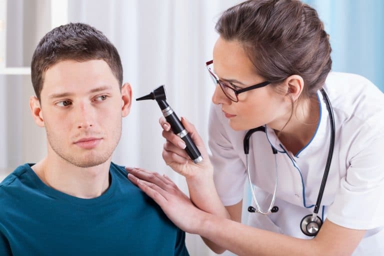 Young laryngologist examining