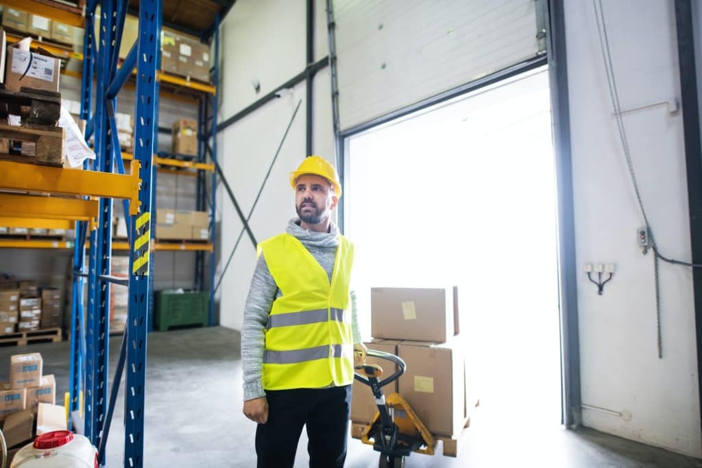 מור ושות׳ חברת עורכי דין ונוטריון Male Warehouse Worker Pulling a Pallet Truck.