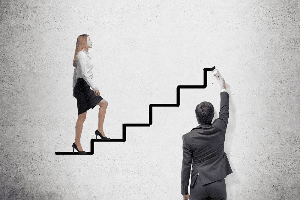A businessman and a woman are climbing up a set of stairs.