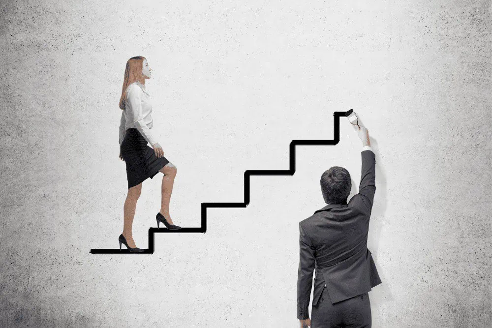 A businessman and a woman are climbing up a set of stairs.
