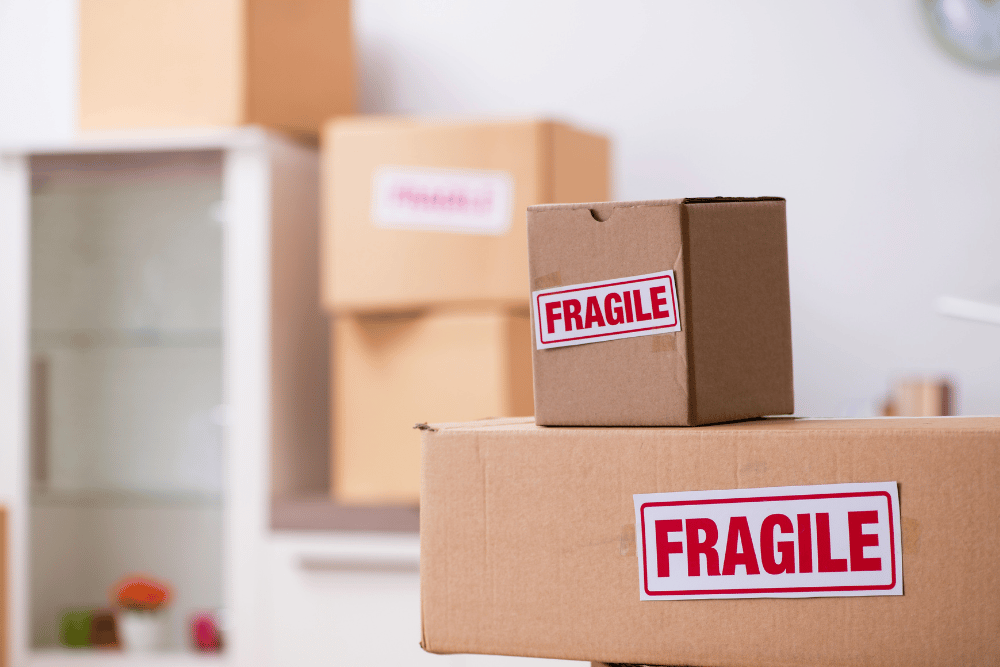 Fragile moving boxes on a table in a room.